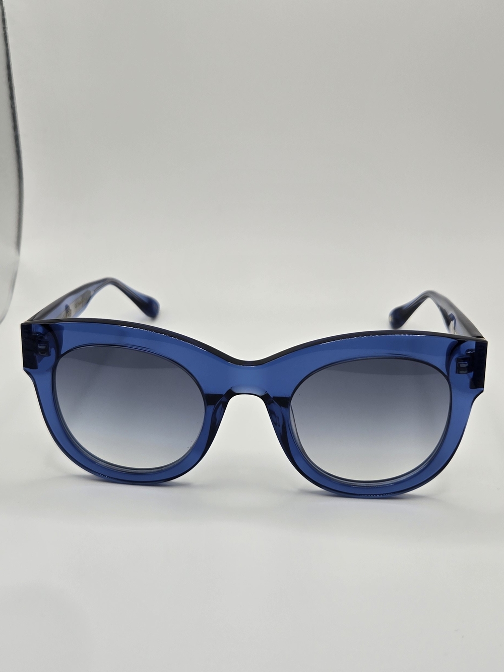 Aperçu sunglasses featuring a bold acetate frame and gold tone branding